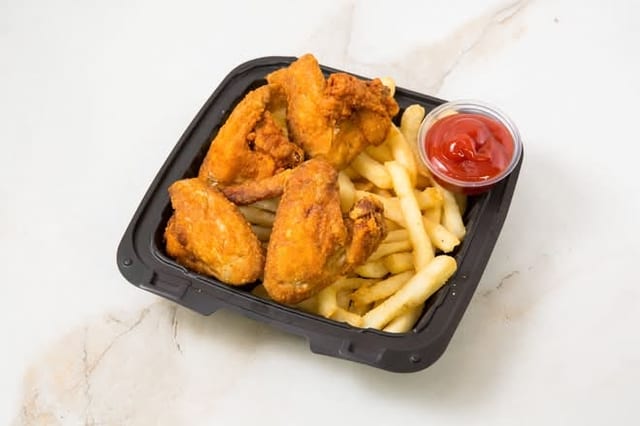4 Chicken Wings with French Fries.